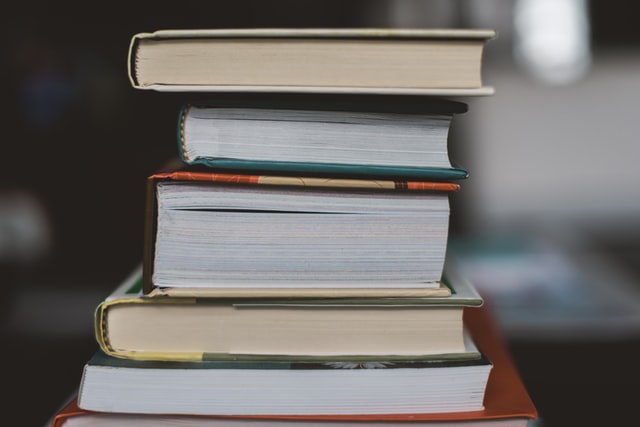 A stack of hardcover books.